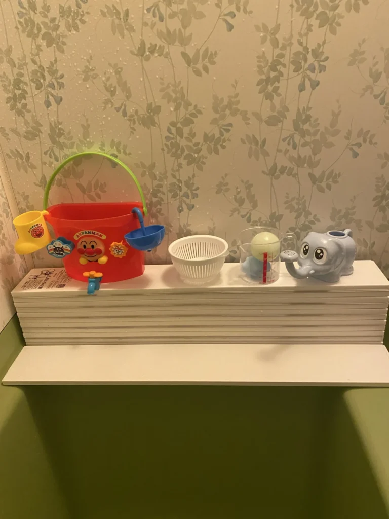 1歳3ヶ月ごろから定着したお風呂おもちゃセット。蛇口付きアンパンマンバケツとミニザル、計量カップ